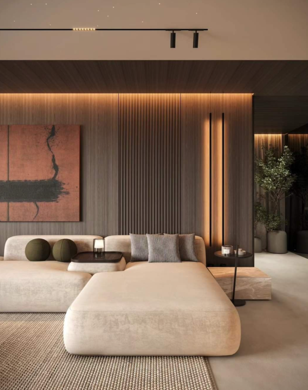 Salon contemporain avec grand canapé beige, éclairé par des bandeaux lumineux muraux et un rail de spots au plafond.