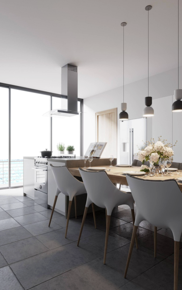 Suspensions design alignées au-dessus de la table d’une cuisine moderne, créant un éclairage chaleureux et convivial.
