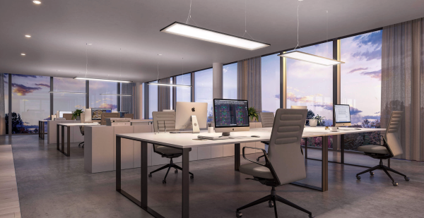 Modern and spacious office bathed in evening light, with large windows, light furniture, and suspended lighting.