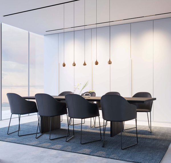 Modern meeting room with a large dark wood table, elegant black chairs, and minimalist pendant lighting aligned above the table.