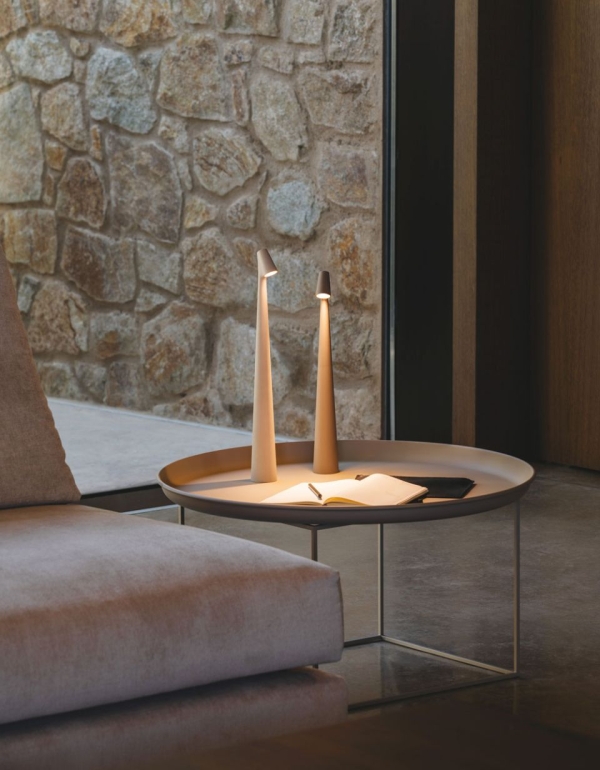 Small table lamp with a slender conical base topped with an elegant head.