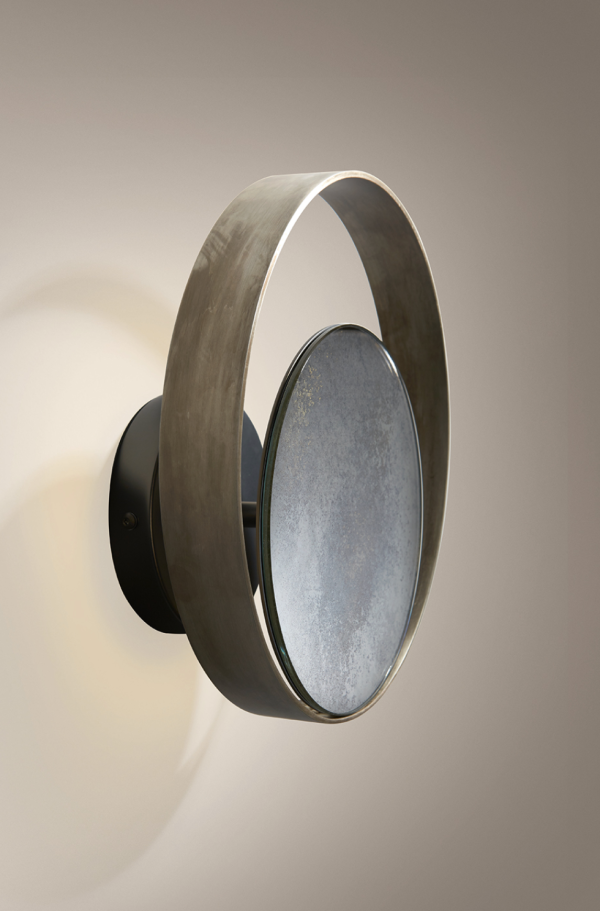 Designer metal wall light with a central reflective disc surrounded by a circular ring.