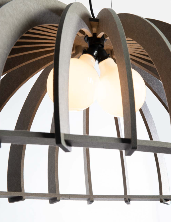 Close-up of an open-structured acoustic pendant light made of curved grey slats, revealing several bulbs emitting a warm light.